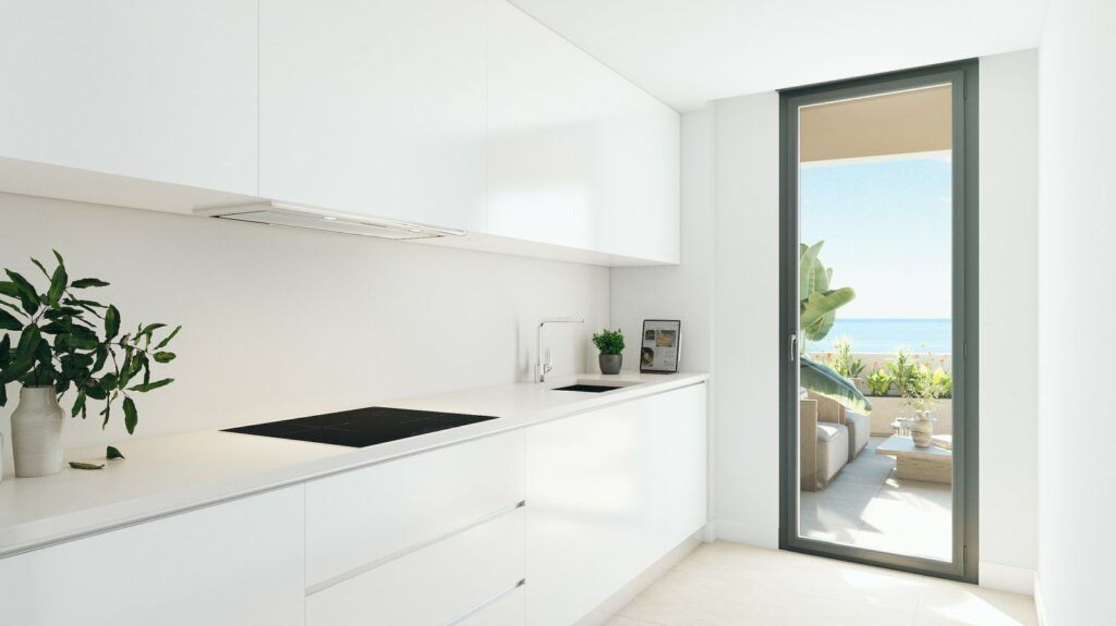 Cuisine blanche moderne avec vue océan, porte vitrée, design minimaliste.